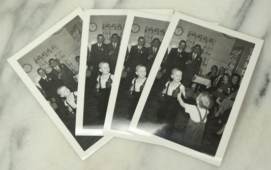 Lot 116 - Grouping Of Four Identical Snap Shot Photographs Of Two Young Boys Play Boxing With Gloves While Amused Family Members Look On