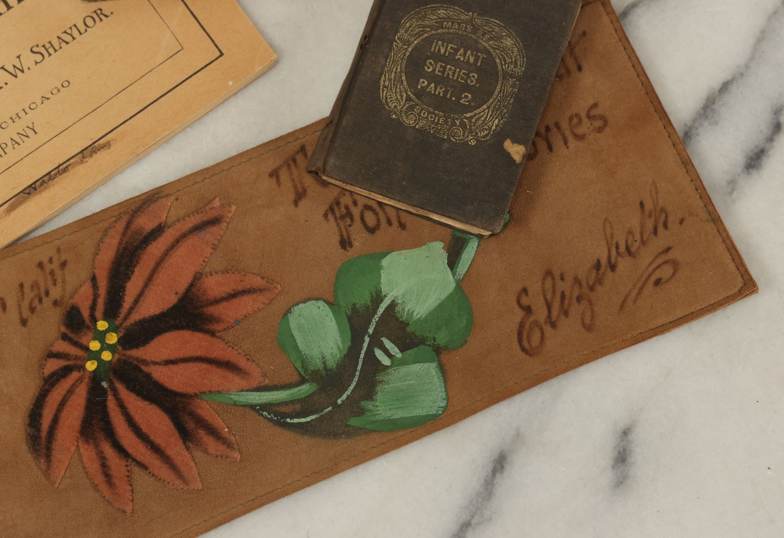 Lot 129 - Grouping Of Four Pieces Of Ephemera Including The Land Of The Pilgrim Fathers Book, Harper's Penmanship Book, Leather Blotter From Long Beach, California, And Infant Series Book