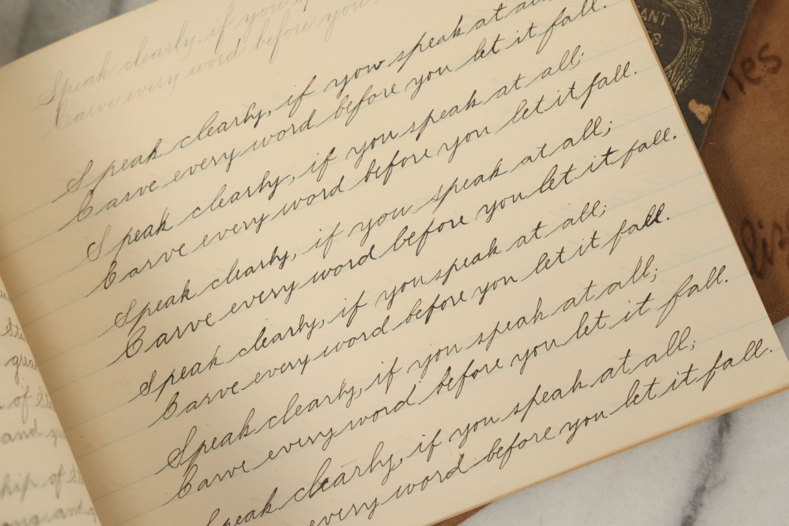 Lot 129 - Grouping Of Four Pieces Of Ephemera Including The Land Of The Pilgrim Fathers Book, Harper's Penmanship Book, Leather Blotter From Long Beach, California, And Infant Series Book