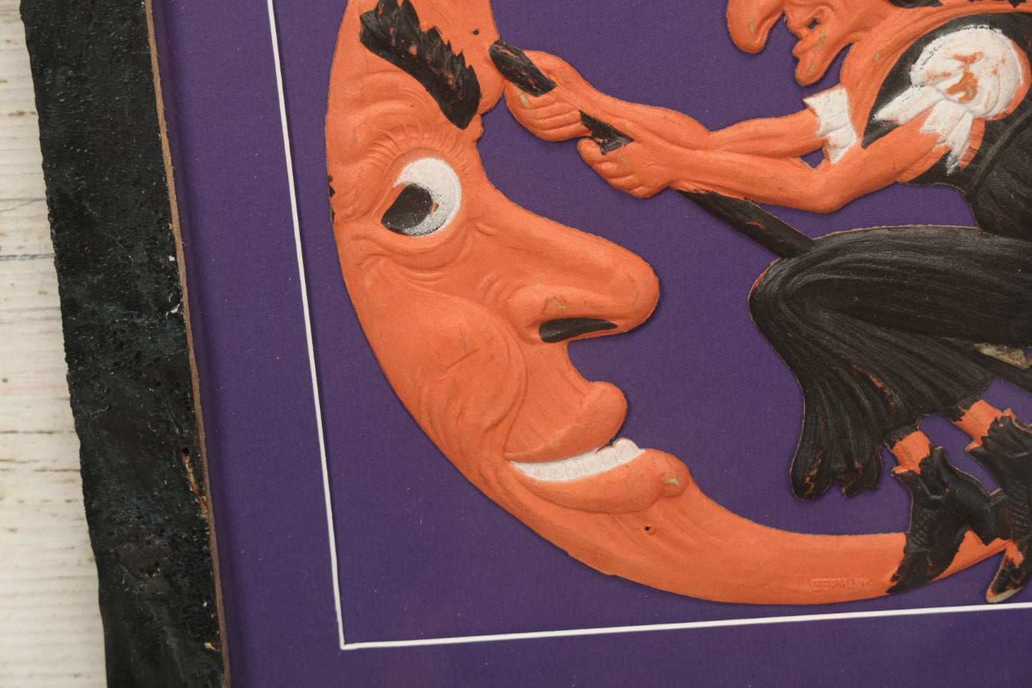 Lot 010 - Antique Witch On Broom With Moon Man Embossed Cardboard Paper Halloween Decoration, Made In Germany, In Custom Frame, 16-3/8" x 15-3/8"