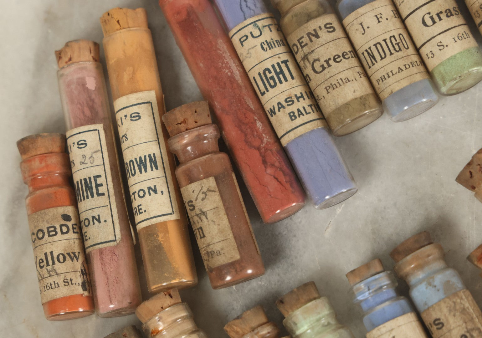 Lot 074 - Grouping Of 20+ Antique Glass Vial Bottles Of Various Paints And Pigments, Powders, By Various Manufacturers, As Found, With Paper Labels