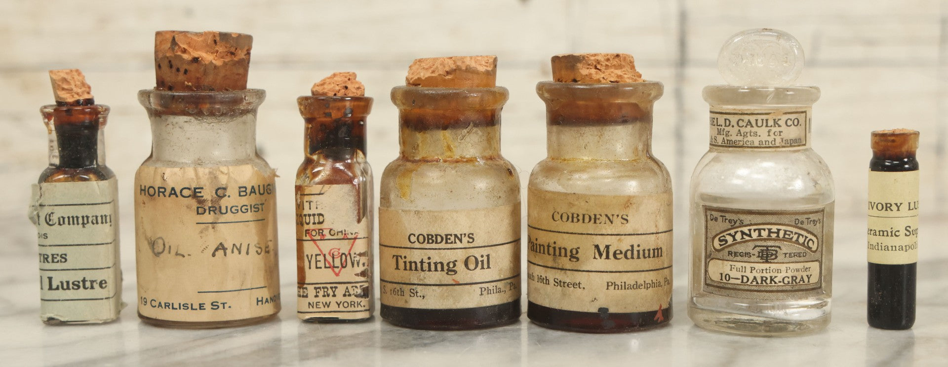 Lot 075 - Grouping Of 7 Antique Glass Bottles For Artists Supplies, Including Tinting Oil, Oil Anise, Lustre, And Others, As Found, Various Manufacturers