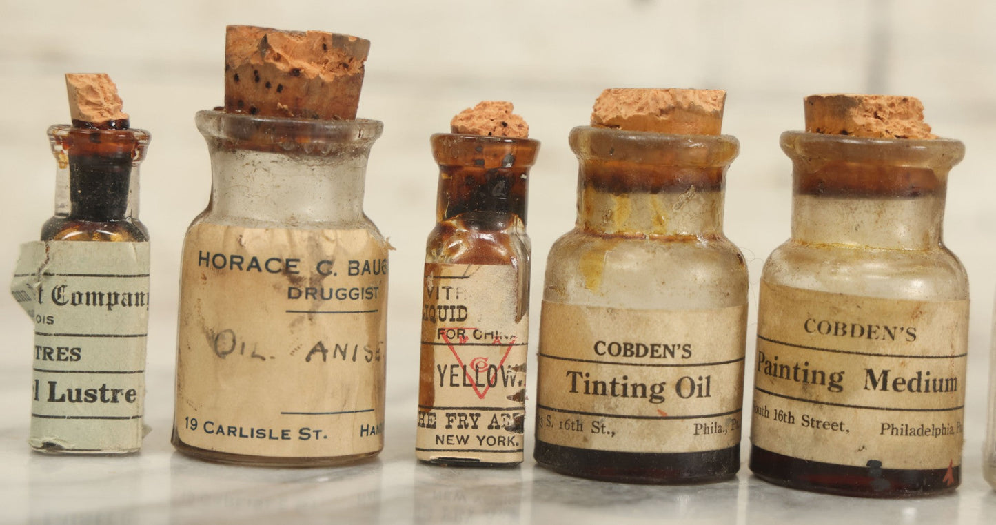 Lot 075 - Grouping Of 7 Antique Glass Bottles For Artists Supplies, Including Tinting Oil, Oil Anise, Lustre, And Others, As Found, Various Manufacturers