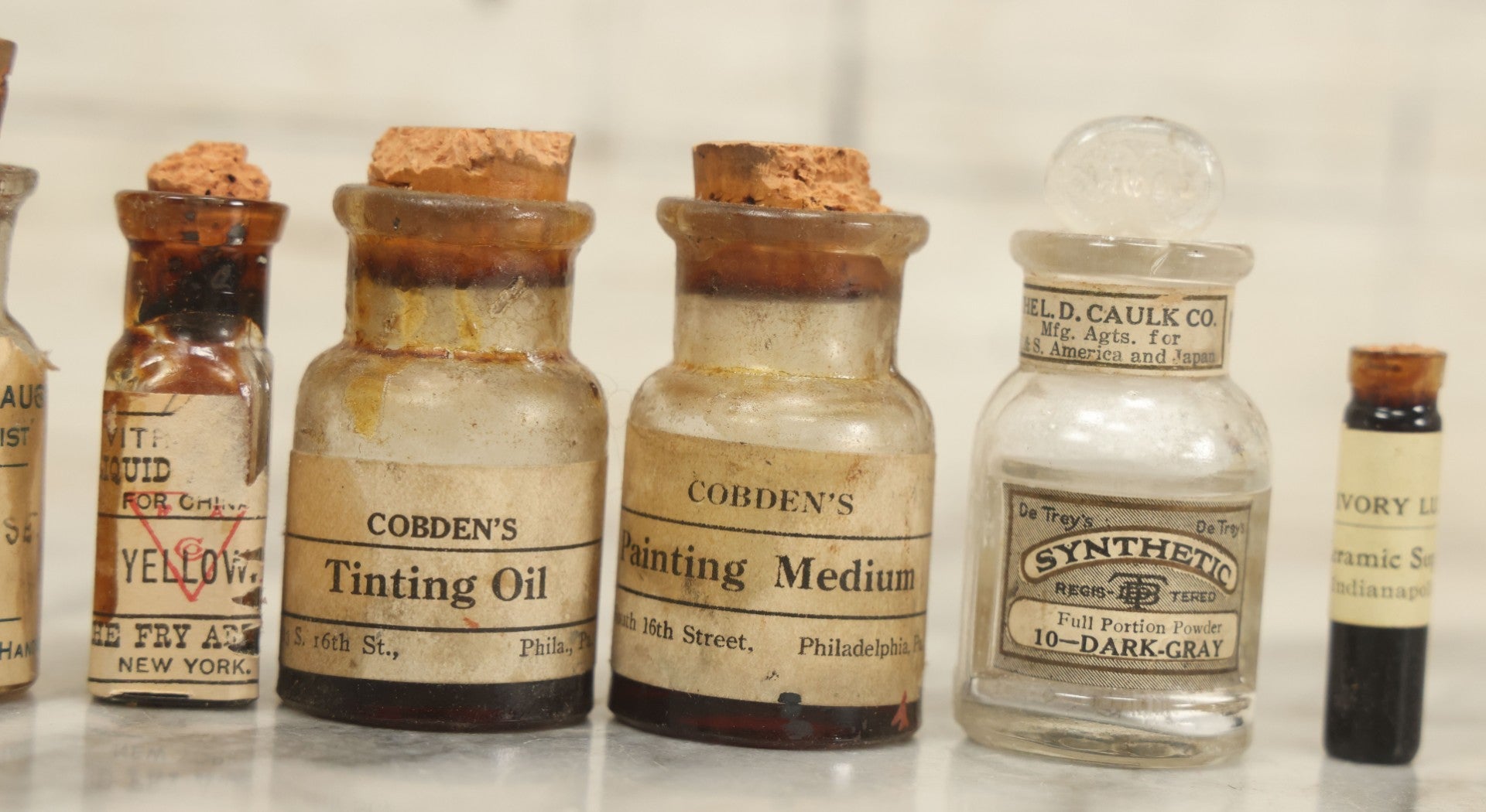 Lot 075 - Grouping Of 7 Antique Glass Bottles For Artists Supplies, Including Tinting Oil, Oil Anise, Lustre, And Others, As Found, Various Manufacturers