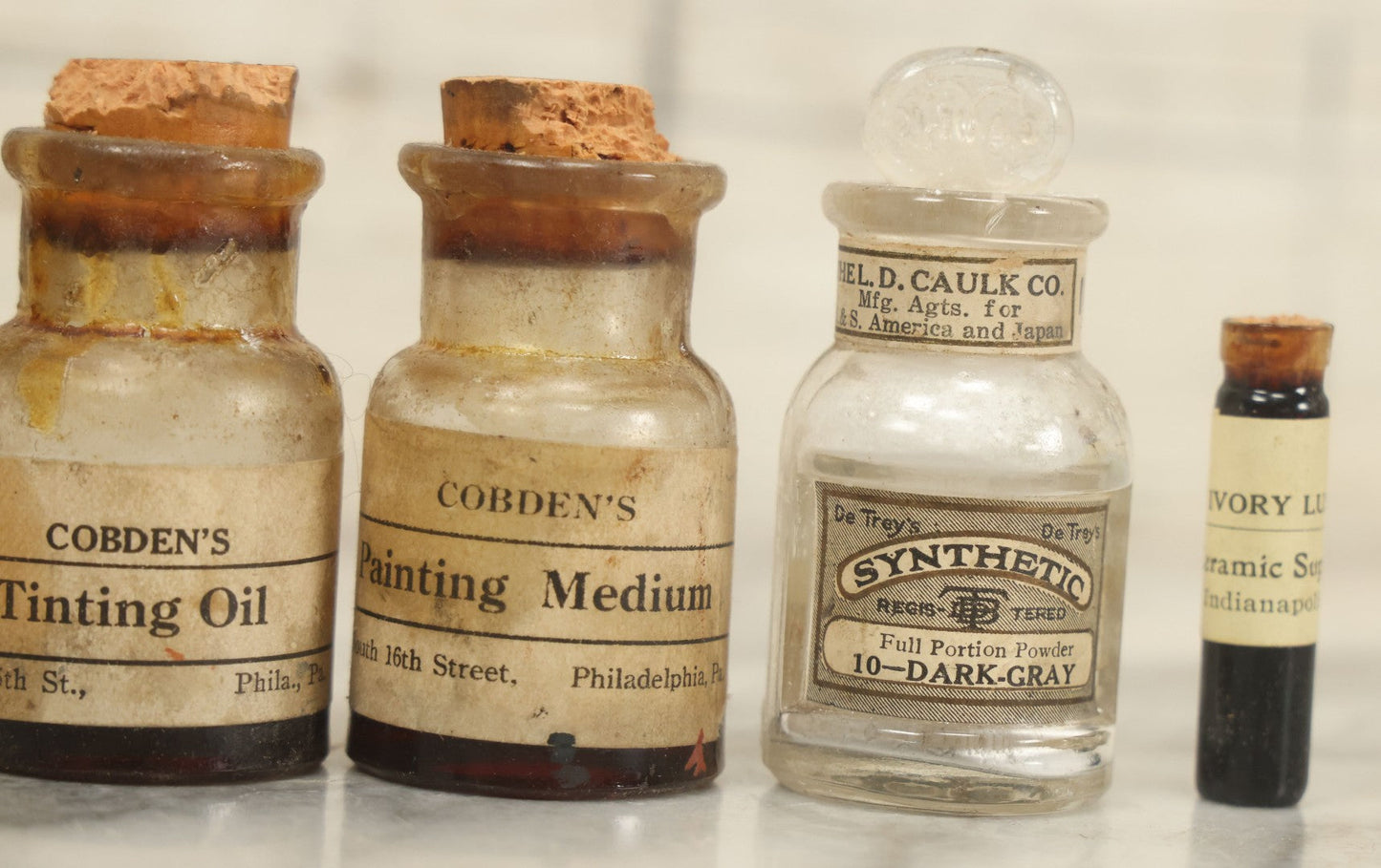 Lot 075 - Grouping Of 7 Antique Glass Bottles For Artists Supplies, Including Tinting Oil, Oil Anise, Lustre, And Others, As Found, Various Manufacturers