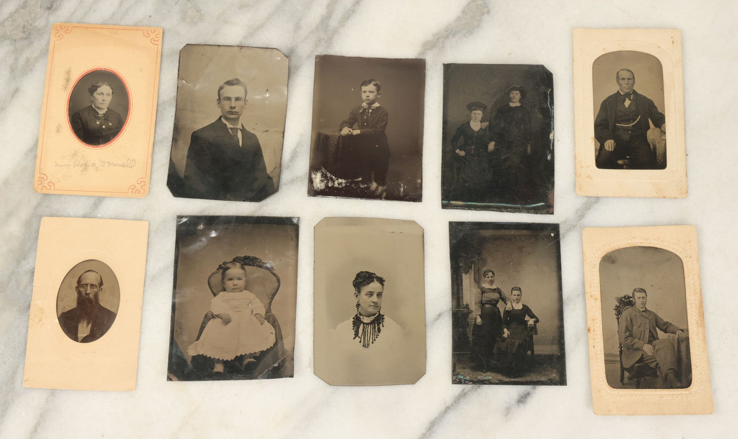 Lot 094 - Grouping Of Ten Tintypes Of Men, Women, And Children, Including Old Man With Beard, Man With Watch Chain, Boy Standing At Table, Others, Four With Paper Frames