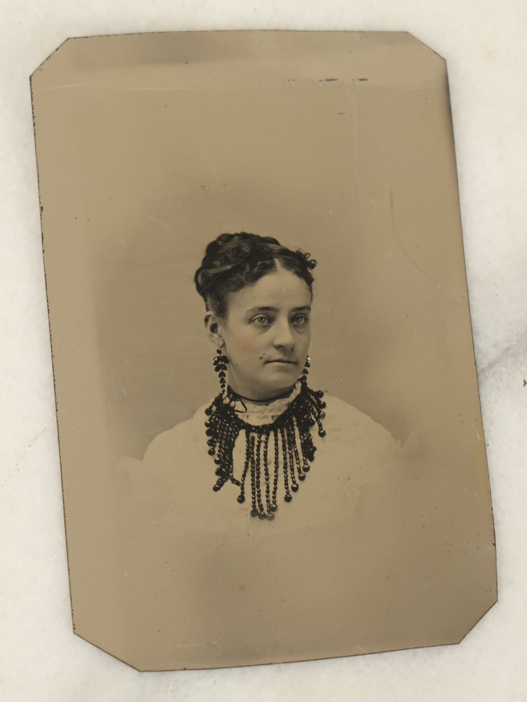 Lot 094 - Grouping Of Ten Tintypes Of Men, Women, And Children, Including Old Man With Beard, Man With Watch Chain, Boy Standing At Table, Others, Four With Paper Frames