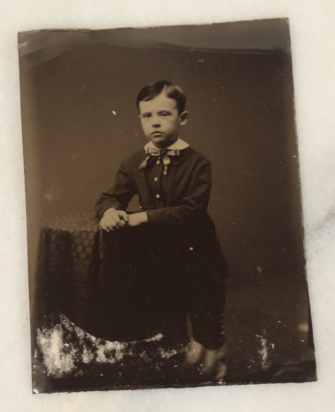 Lot 094 - Grouping Of Ten Tintypes Of Men, Women, And Children, Including Old Man With Beard, Man With Watch Chain, Boy Standing At Table, Others, Four With Paper Frames