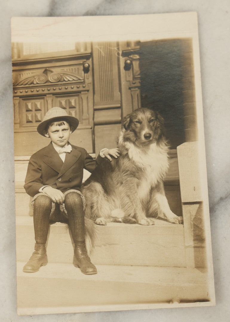 Lot 100 - Single Antique Real Photo Postcard, R.P.P.C., Boy In Hat Sitting On Stoop With Dog