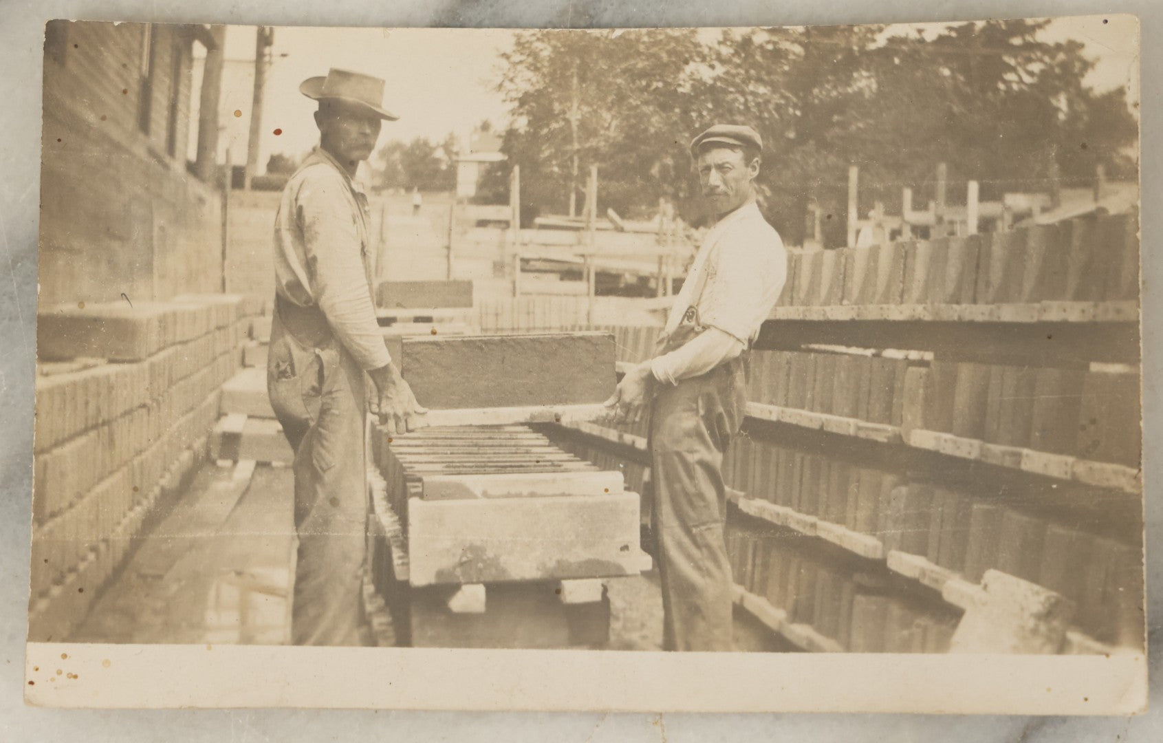 Lot 101 - Single Antique Real Photo Postcard, R.P.P.C., Occupational, Two Men Holding Large Piece Of Stone Granite, Laborers, House Builders, With Information On Verso