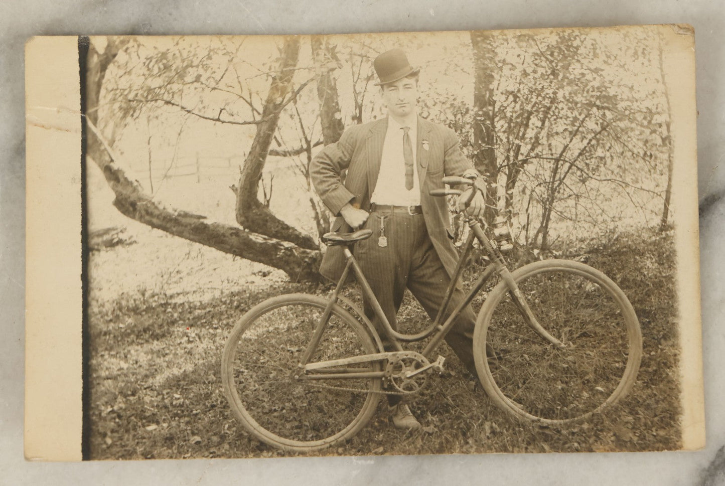 Lot 102 - Single Antique Real Photo Postcard, R.P.P.C., Man In Bowler Hat And Pinstripe Suit Standing With Bicycle, Bike, Dated 1910