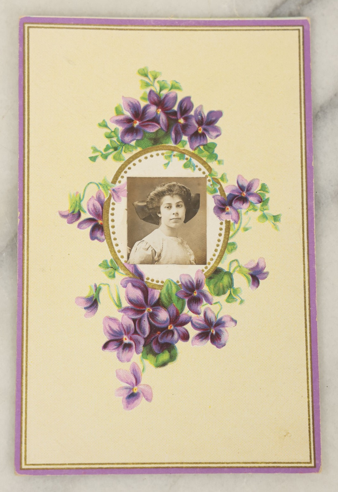 Lot 104 - Single Antique Postcard With Clipped Photo Of Young Woman With Large Bow, Purple Flower Design, Signed On Verso
