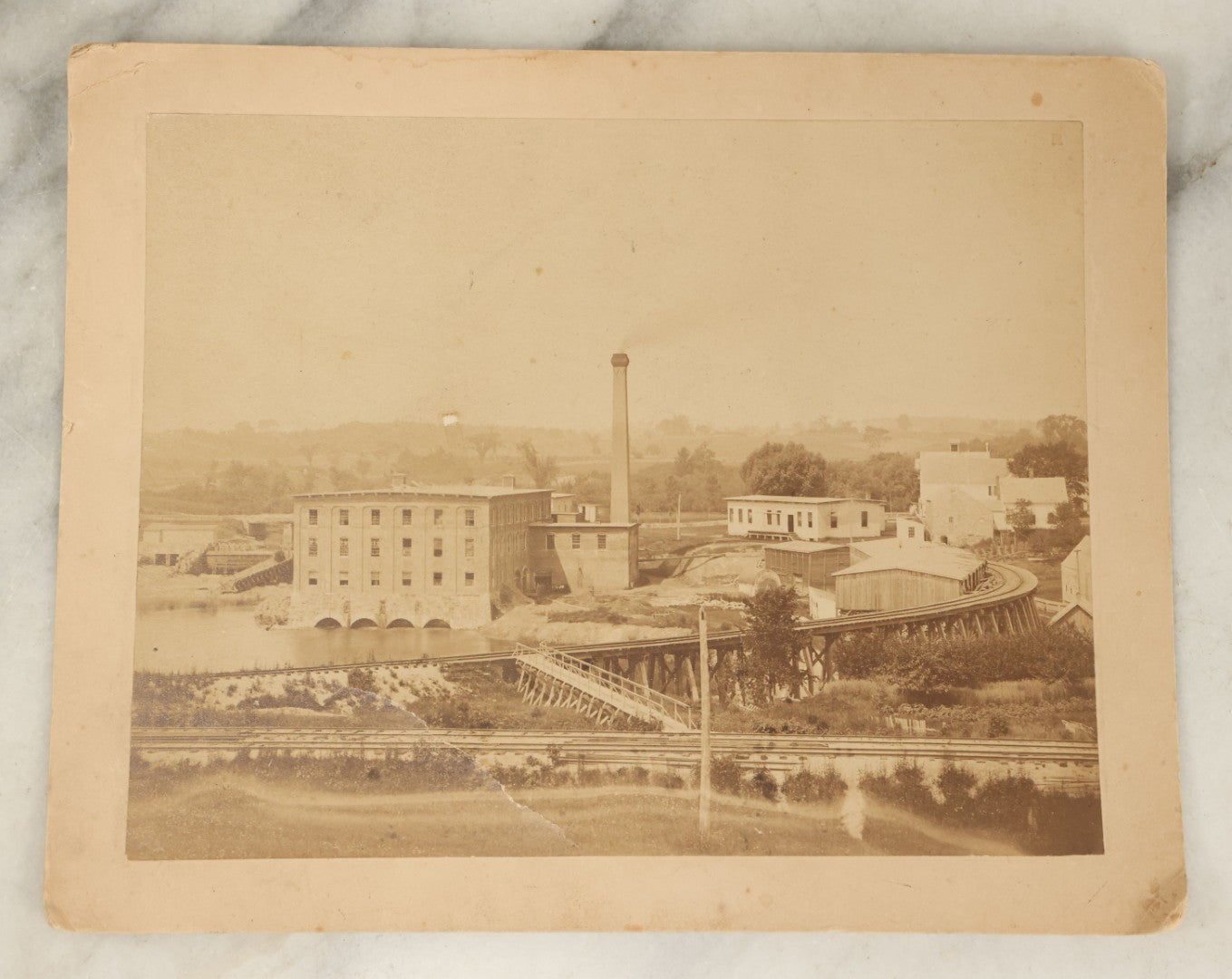 Lot 115 - Antique Boarded Photograph Of A Factory With Train Tracks, Chimney, Back Marked "Everett Coffin" In Pencil, Note States Chimney Removed 1945
