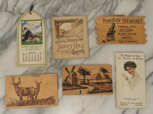 Lot 120 - Grouping Of Six Pieces Of Vintage And Antique Ephemera Including Wooden Postcards, Fair Skies Booklet, Advertising Calendar, And More