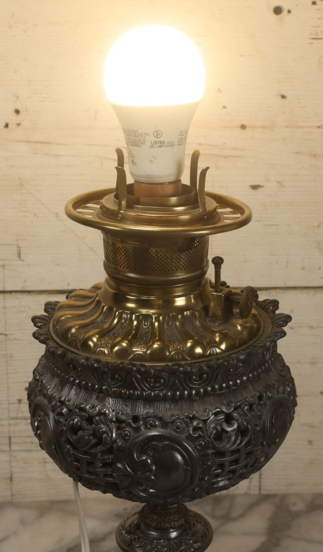 Lot 006 - Antique Victorian Electrified Gone With The Wind Oil Lamp With Ornate Metal Base & Embossed Cherub Glass Globe, Note Cracks, Repairs To Globe, Working Condition, Approximately 26" Overall Height