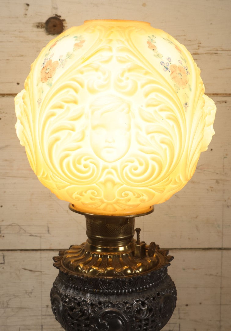 Lot 006 - Antique Victorian Electrified Gone With The Wind Oil Lamp With Ornate Metal Base & Embossed Cherub Glass Globe, Note Cracks, Repairs To Globe, Working Condition, Approximately 26" Overall Height