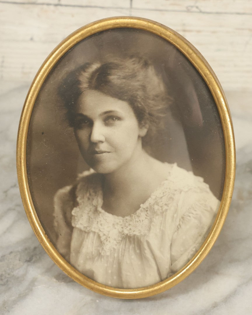 Lot 127 - Antique Framed Portrait Photo Of A Pretty Young Smiling Woman In A Brass Frame By John Wanamaker, 4-1/4" x 5-5/8"