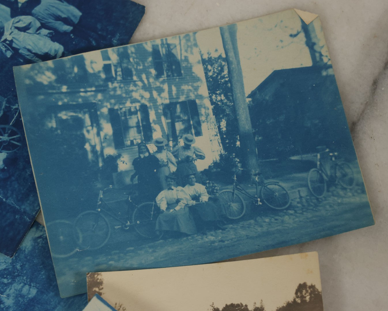 Lot 170 - Grouping Of 9 Snapshot Photographs Including 8 Cyanotypes Of Victorian Women And Children, Women With Bicycles, Skiing, Etc.
