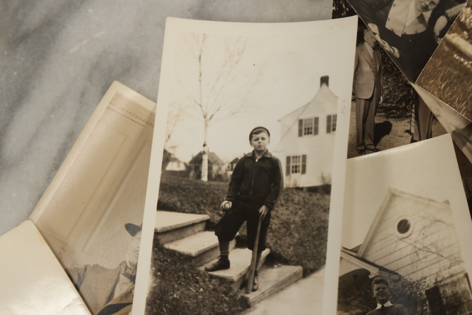 Lot 173 - Grouping Of 20+ Vintage And Antique Snapshot Photographs Including Boy With Baseball Bat, Boy With Bugle, Boy With Plane, Boy Riding Bike, Old Man In Stovepipe Hat, Etc.