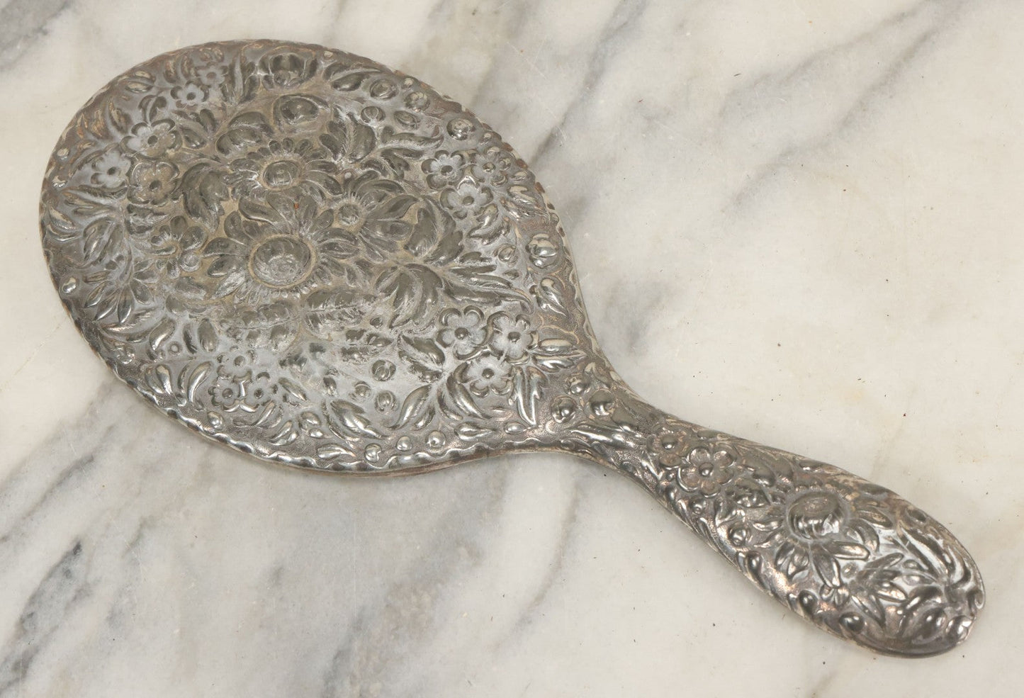 Lot 025 - Antique Silverplate Hand Mirror, Floral Repoussé Design, Beveled Glass, Note Wear To Mirror