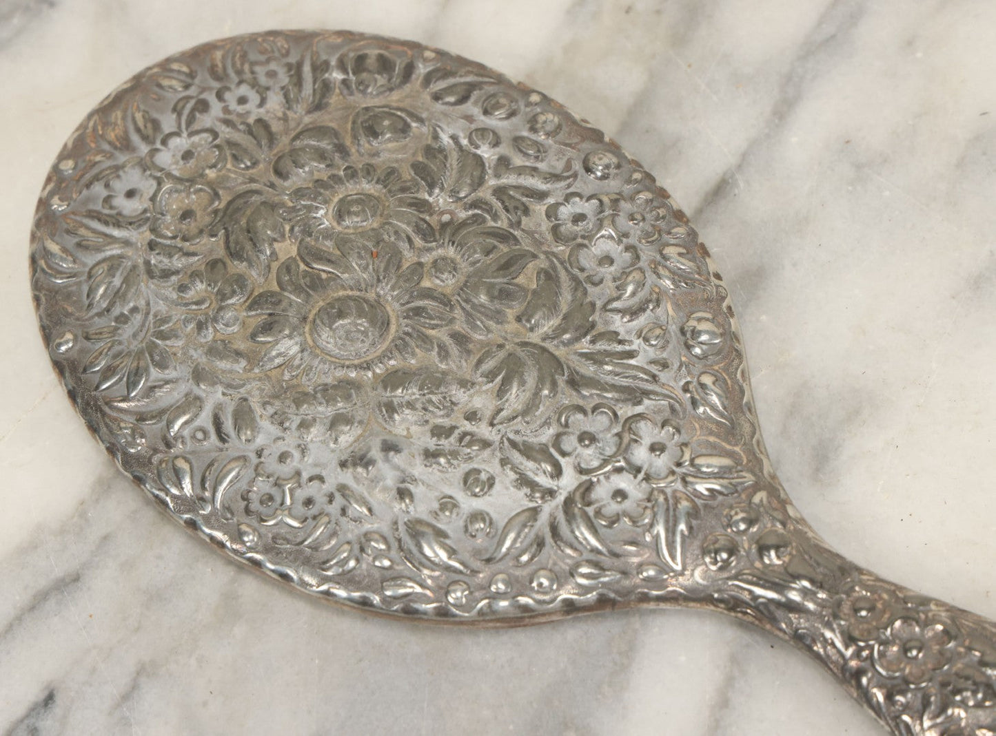 Lot 025 - Antique Silverplate Hand Mirror, Floral Repoussé Design, Beveled Glass, Note Wear To Mirror