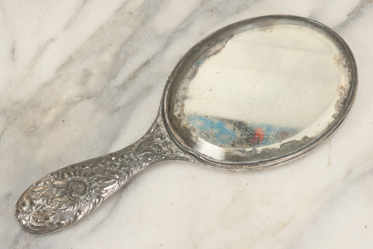 Lot 025 - Antique Silverplate Hand Mirror, Floral Repoussé Design, Beveled Glass, Note Wear To Mirror