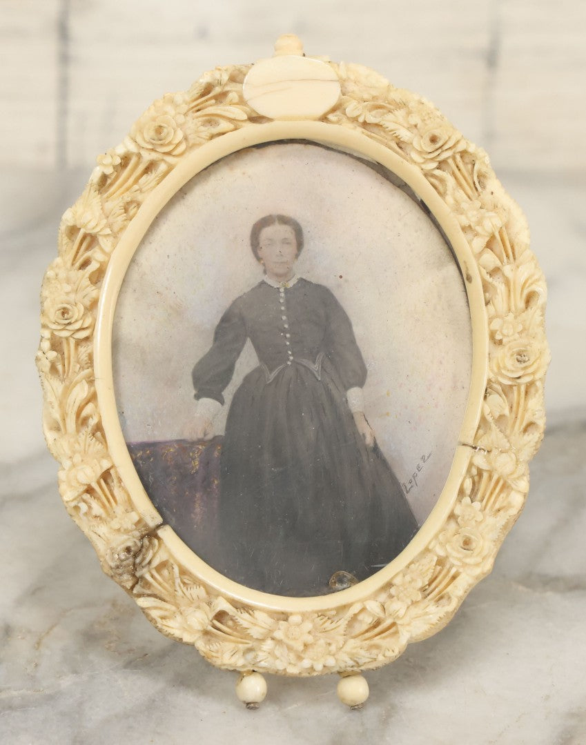 Lot 046 - Antique Painted Over Photo Portrait Miniature Of A Woman, Signed Lopez, In Ornate Carved Scrimshaw Bone Floral Frame, Note Repairs