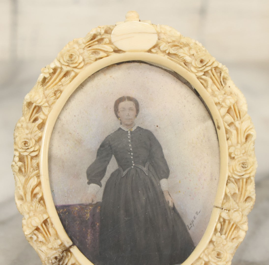 Lot 046 - Antique Painted Over Photo Portrait Miniature Of A Woman, Signed Lopez, In Ornate Carved Scrimshaw Bone Floral Frame, Note Repairs