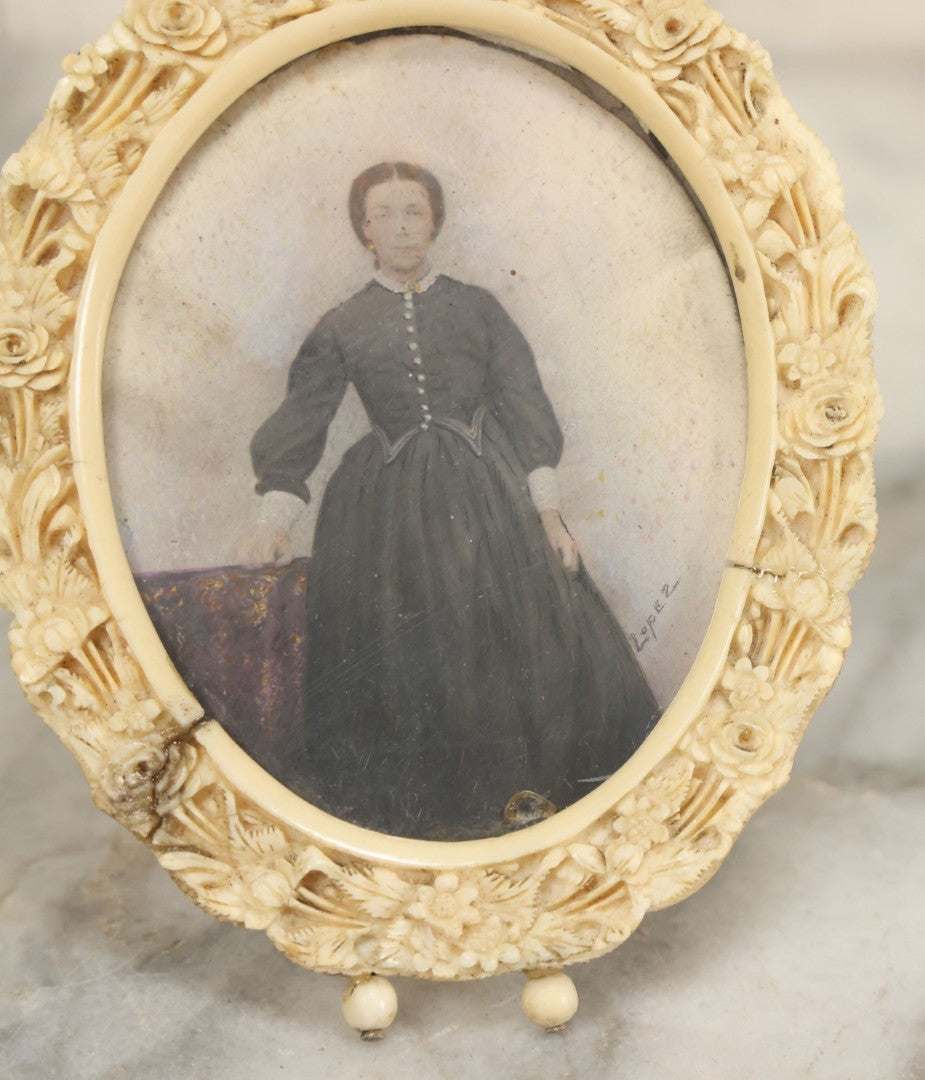 Lot 046 - Antique Painted Over Photo Portrait Miniature Of A Woman, Signed Lopez, In Ornate Carved Scrimshaw Bone Floral Frame, Note Repairs