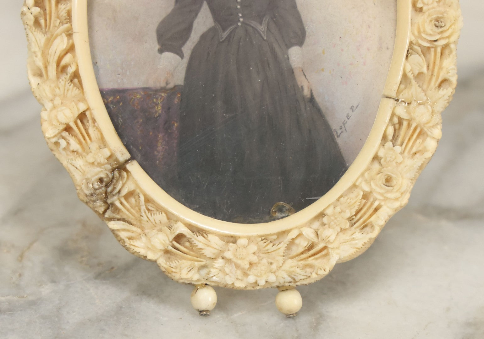 Lot 046 - Antique Painted Over Photo Portrait Miniature Of A Woman, Signed Lopez, In Ornate Carved Scrimshaw Bone Floral Frame, Note Repairs