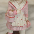 Lot 065 - Antique Hand-Painted Bisque Girl Figural Match Strike, Match Safe, Pink Dress And Bonnet, Likely German