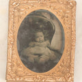 Lot 085 - Antique 1/9th Plate Ruby Ambrotype Photograph Of A Slouching Baby In A Chair
