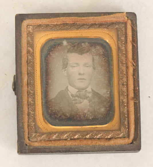 Lot 087 - Antique 1/16th Plate Daguerreotype Of A Young Man In A Bowtie In A Half Leatherette Case