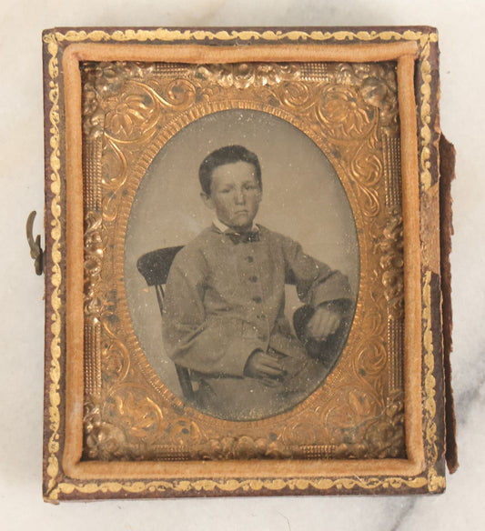Lot 089 - Antique 1/9th Plate Tintype Photograph Of A Young Boy In A Gray Suit With A Bowtie, In Half Leatherette Case