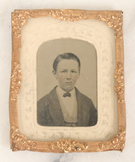Lot 090 - Antique 1/9th Plate Tintype Photograph Of A Young Boy In A Jacket With A Bowtie, White Paper Mat