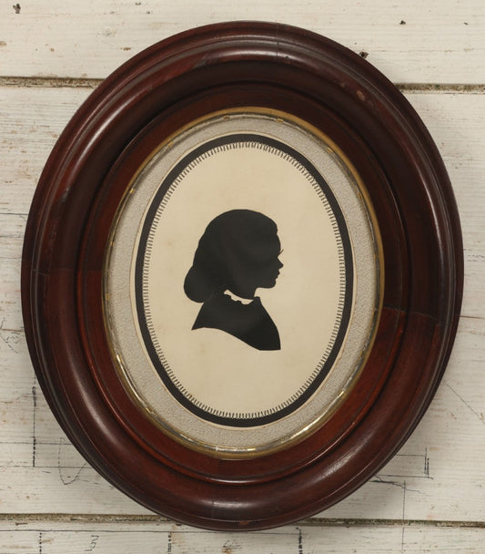 Lot 095 - Antique Hand Cut Paper Silhouette Of A Young Girl In A Deep Oval Frame, 11-3/8 x 13-3/8"