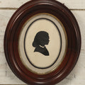 Lot 095 - Antique Hand Cut Paper Silhouette Of A Young Girl In A Deep Oval Frame, 11-3/8 x 13-3/8"