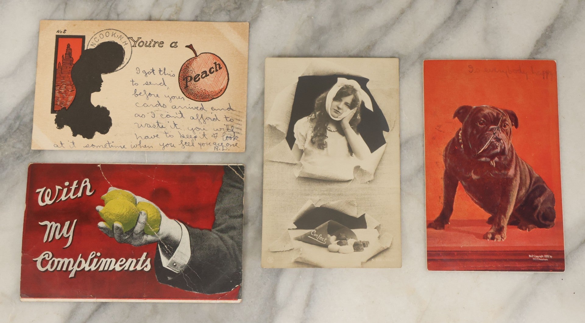 Lot 113 - Grouping Of Four Antique Postcards Including "You're A Peach," Girl With Toothache, Lemons, And Black Pug Dog, Early 20th Century