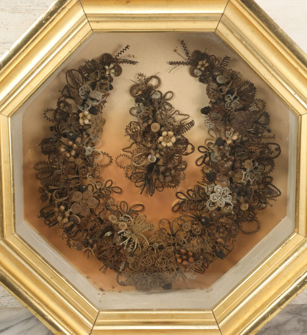 Lot 001 - Antique Victorian Human Hair Work Wreath In Octagon Shadow Box With Paper Label From J.D. Powers' Photograph Rooms, Springfield, Vermont, 20" x 20" x 6"