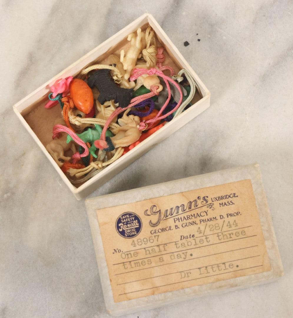Lot 109 - Grouping Of 15+ Vintage Plastic Celluloid Charm Toys Novelties, Made In Japan, In Box From Gunn's Pharmacy, Uxbridge, Massachusetts, As Found