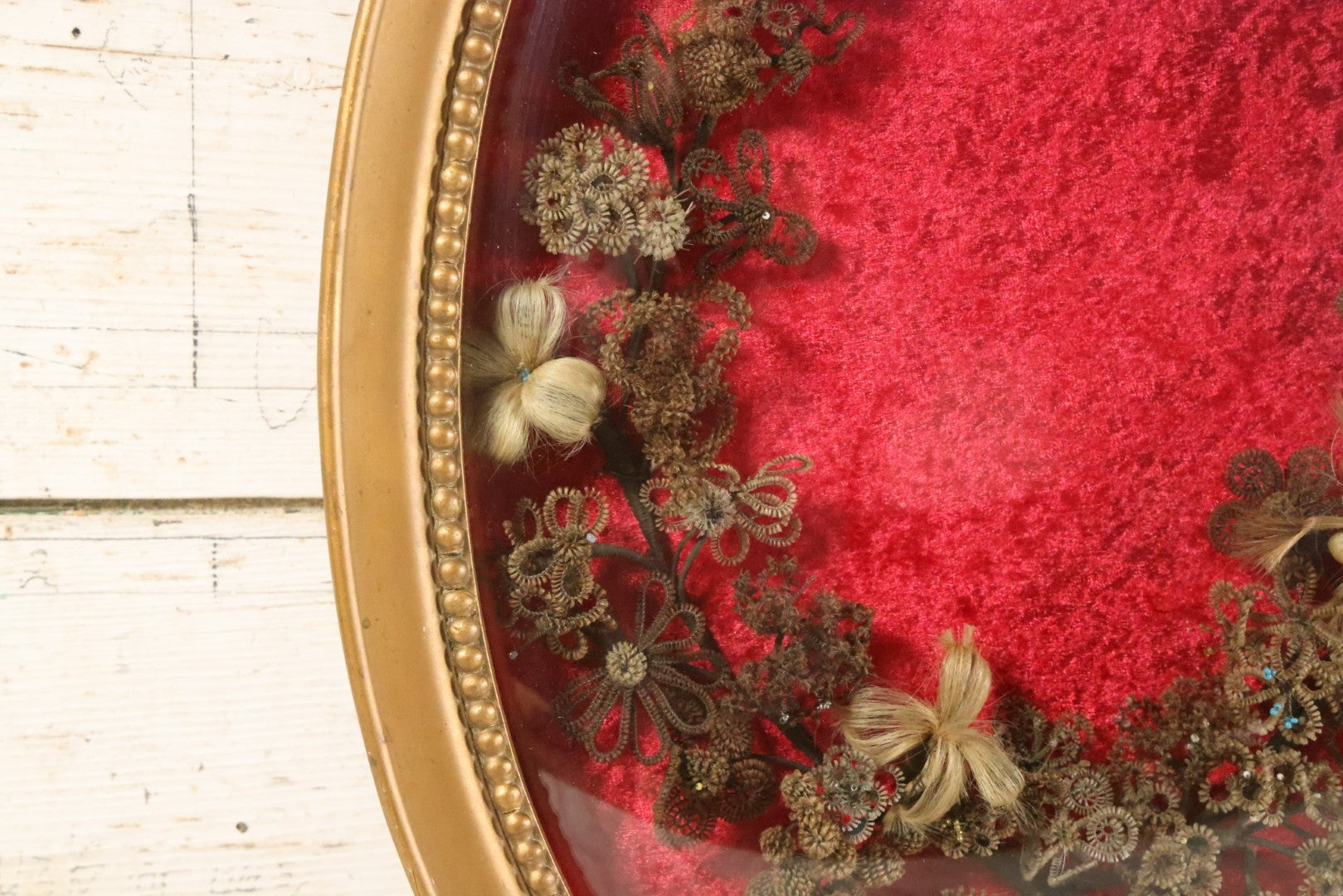 Lot 008 - Antique Victorian Human Hair Work Wreath In Oval Shadow Box With Bubble Glass, Refurbished Faux Red Velvet Back And Surround, 16" x 22"