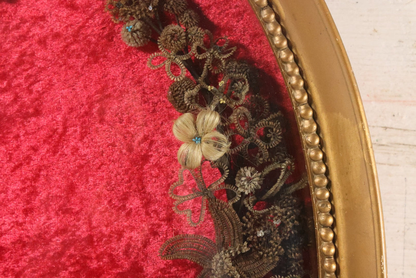 Lot 008 - Antique Victorian Human Hair Work Wreath In Oval Shadow Box With Bubble Glass, Refurbished Faux Red Velvet Back And Surround, 16" x 22"