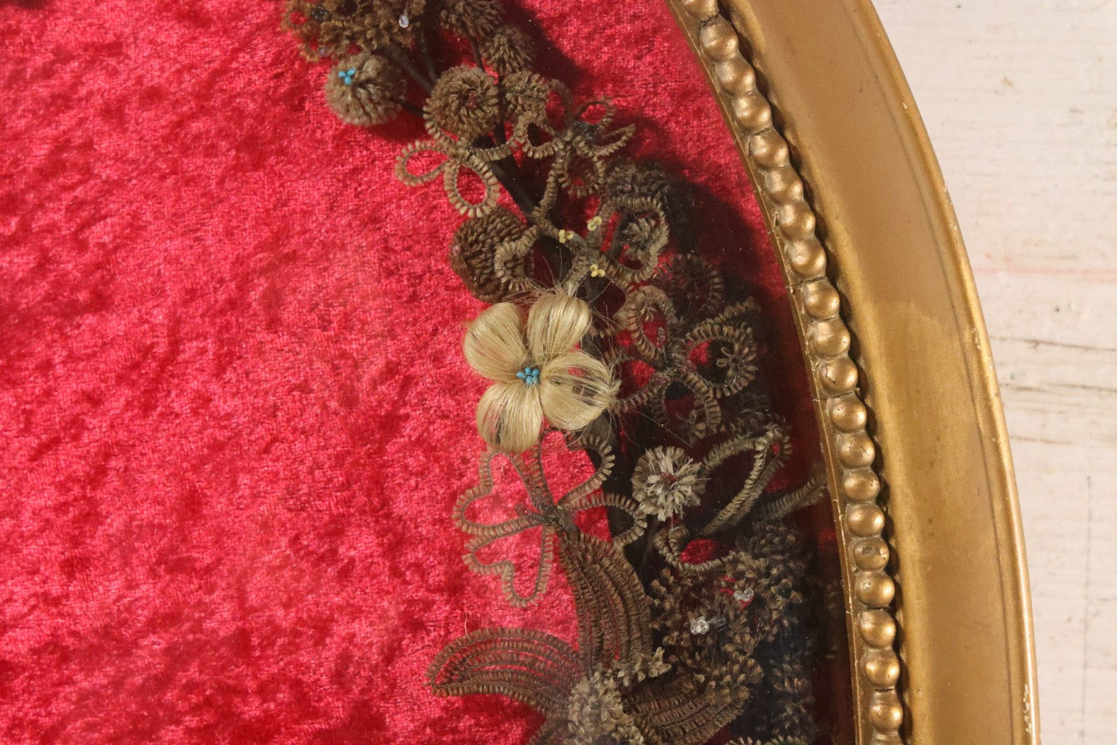 Lot 008 - Antique Victorian Human Hair Work Wreath In Oval Shadow Box With Bubble Glass, Refurbished Faux Red Velvet Back And Surround, 16" x 22"