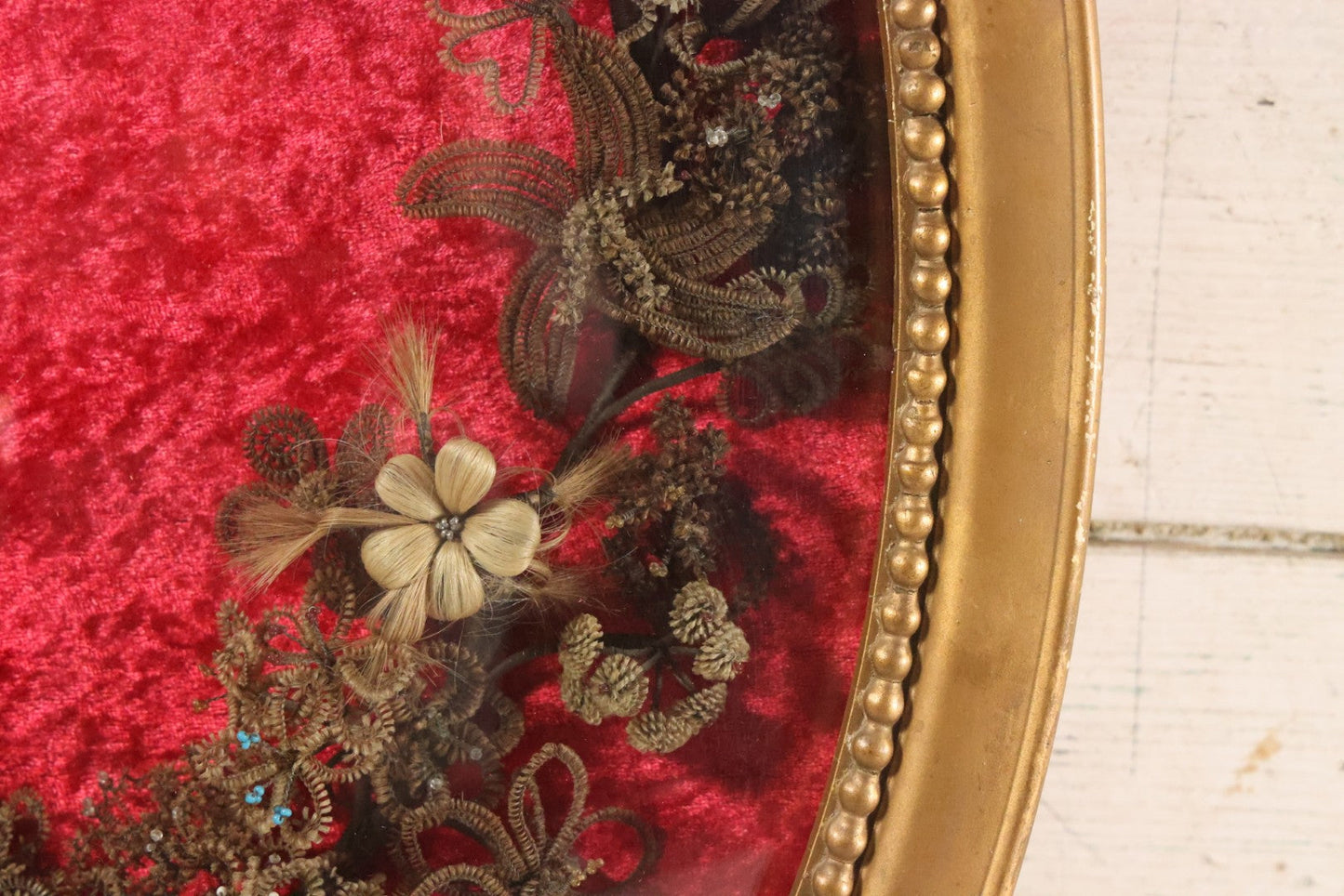 Lot 008 - Antique Victorian Human Hair Work Wreath In Oval Shadow Box With Bubble Glass, Refurbished Faux Red Velvet Back And Surround, 16" x 22"