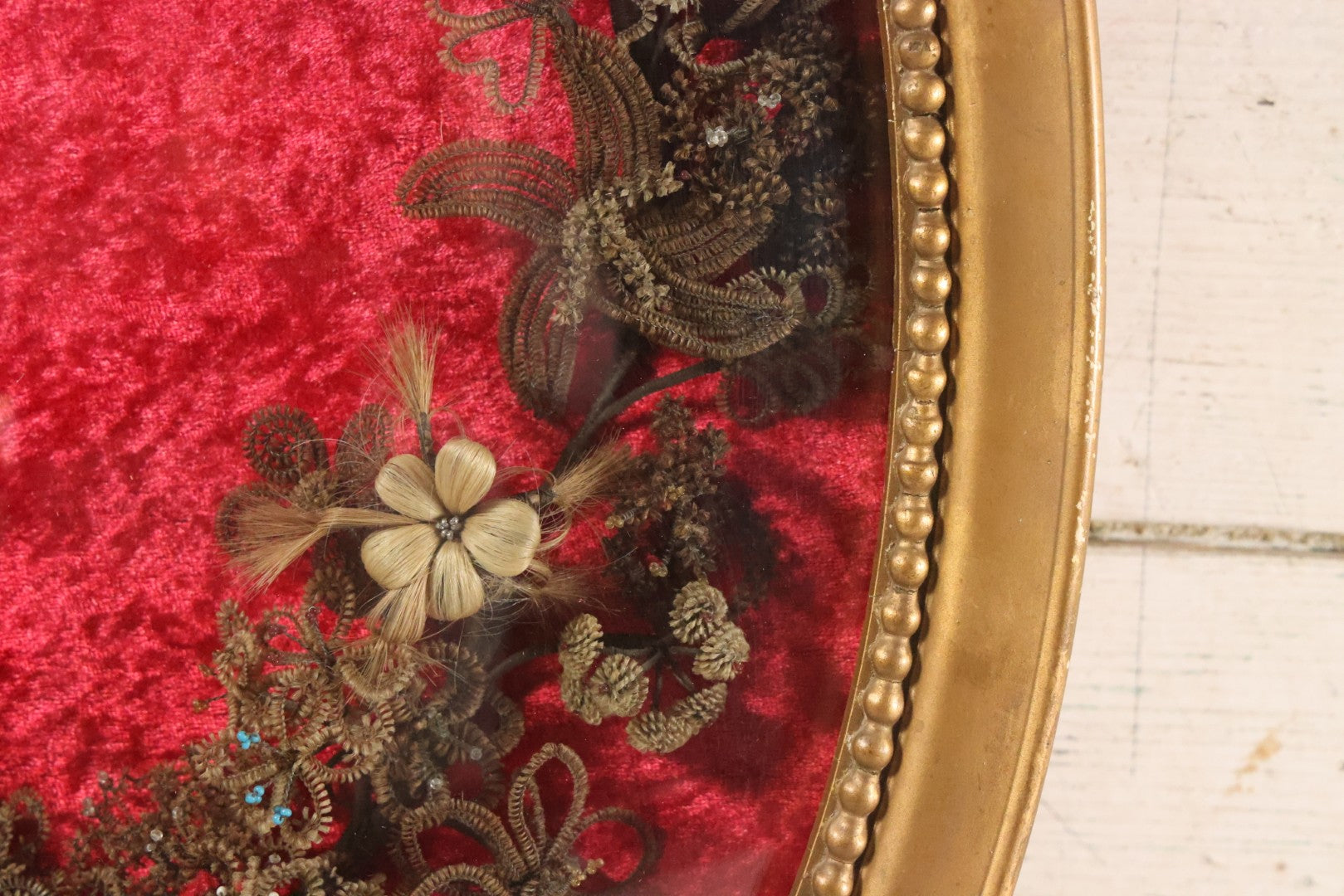 Lot 008 - Antique Victorian Human Hair Work Wreath In Oval Shadow Box With Bubble Glass, Refurbished Faux Red Velvet Back And Surround, 16" x 22"