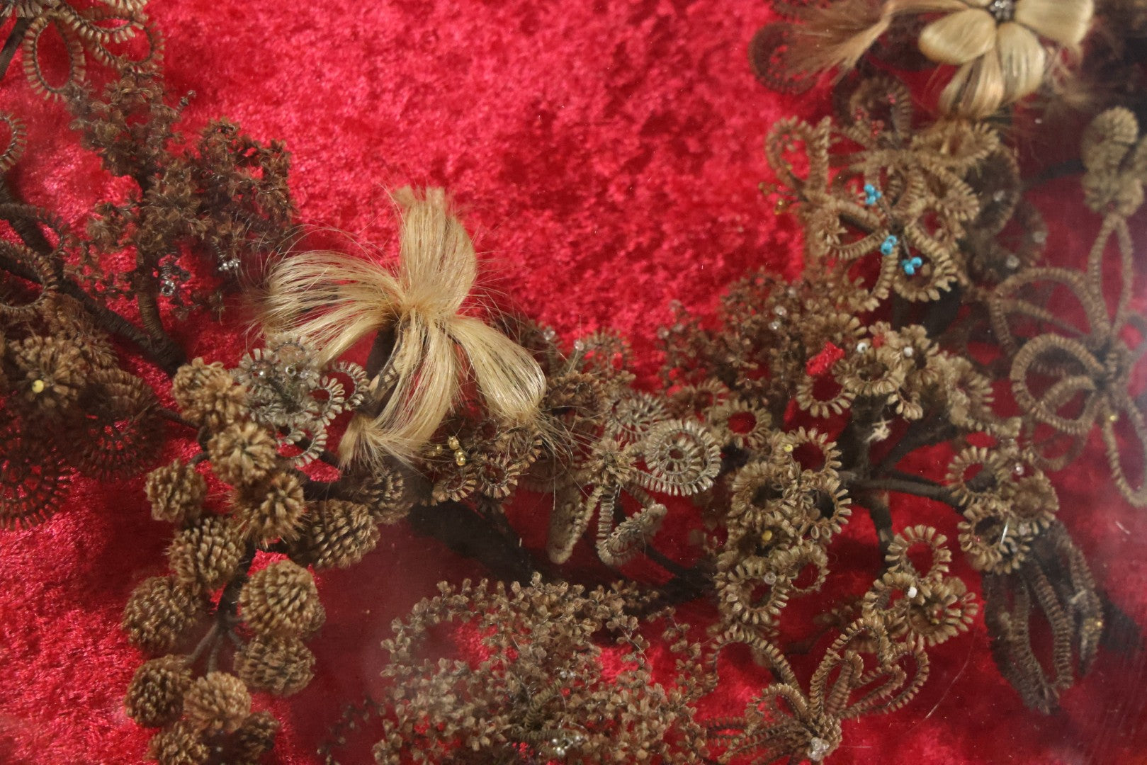 Lot 008 - Antique Victorian Human Hair Work Wreath In Oval Shadow Box With Bubble Glass, Refurbished Faux Red Velvet Back And Surround, 16" x 22"