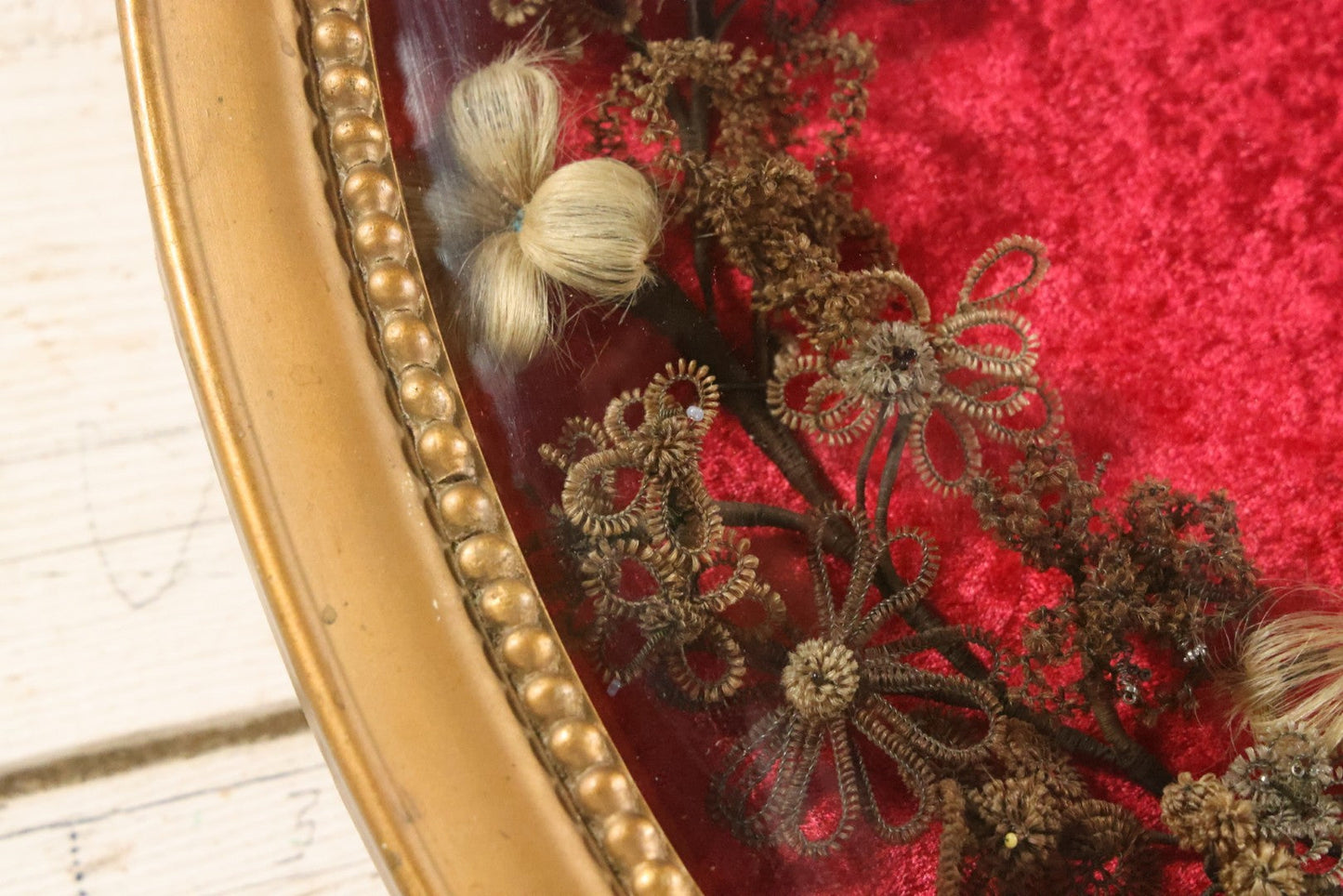 Lot 008 - Antique Victorian Human Hair Work Wreath In Oval Shadow Box With Bubble Glass, Refurbished Faux Red Velvet Back And Surround, 16" x 22"