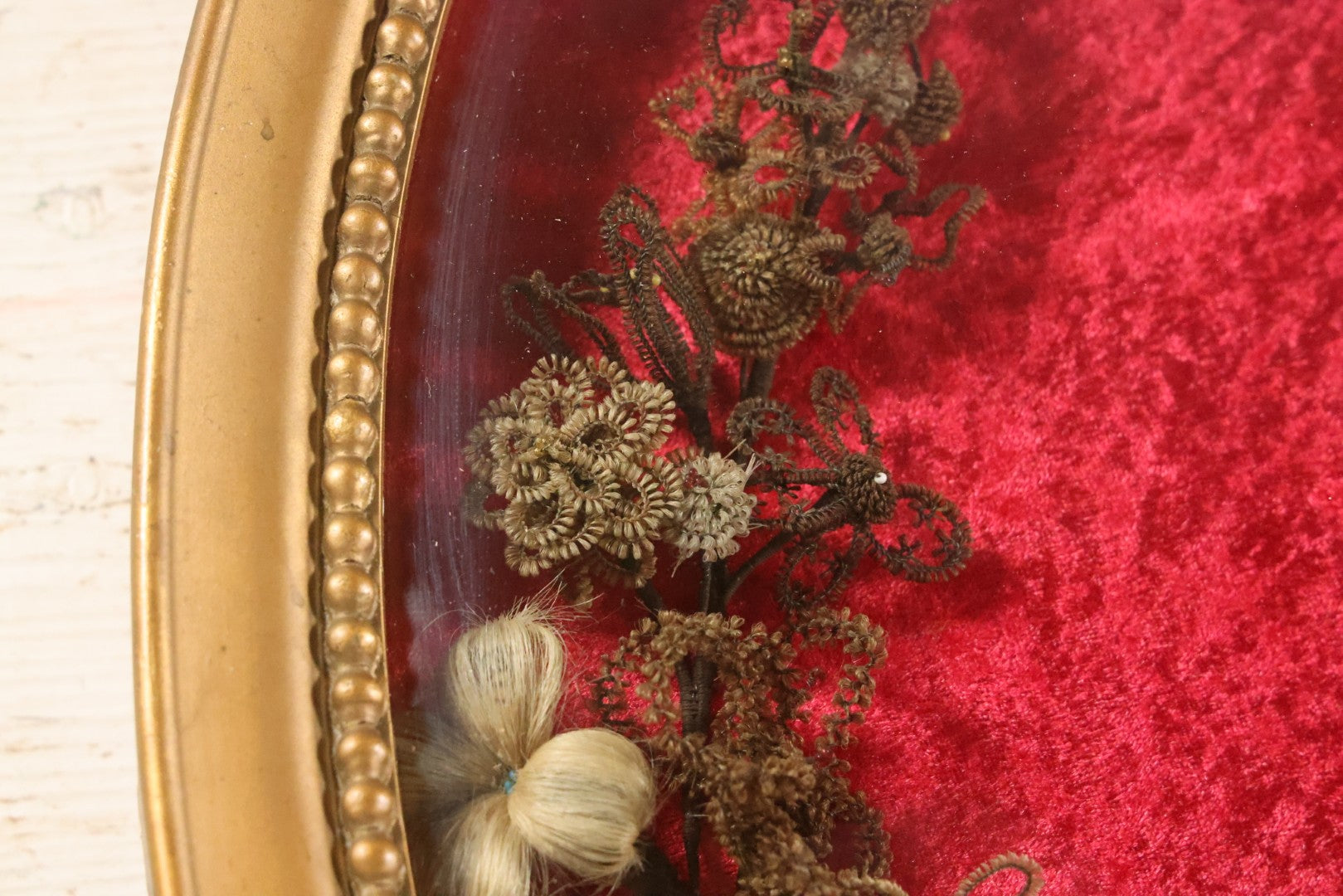 Lot 008 - Antique Victorian Human Hair Work Wreath In Oval Shadow Box With Bubble Glass, Refurbished Faux Red Velvet Back And Surround, 16" x 22"