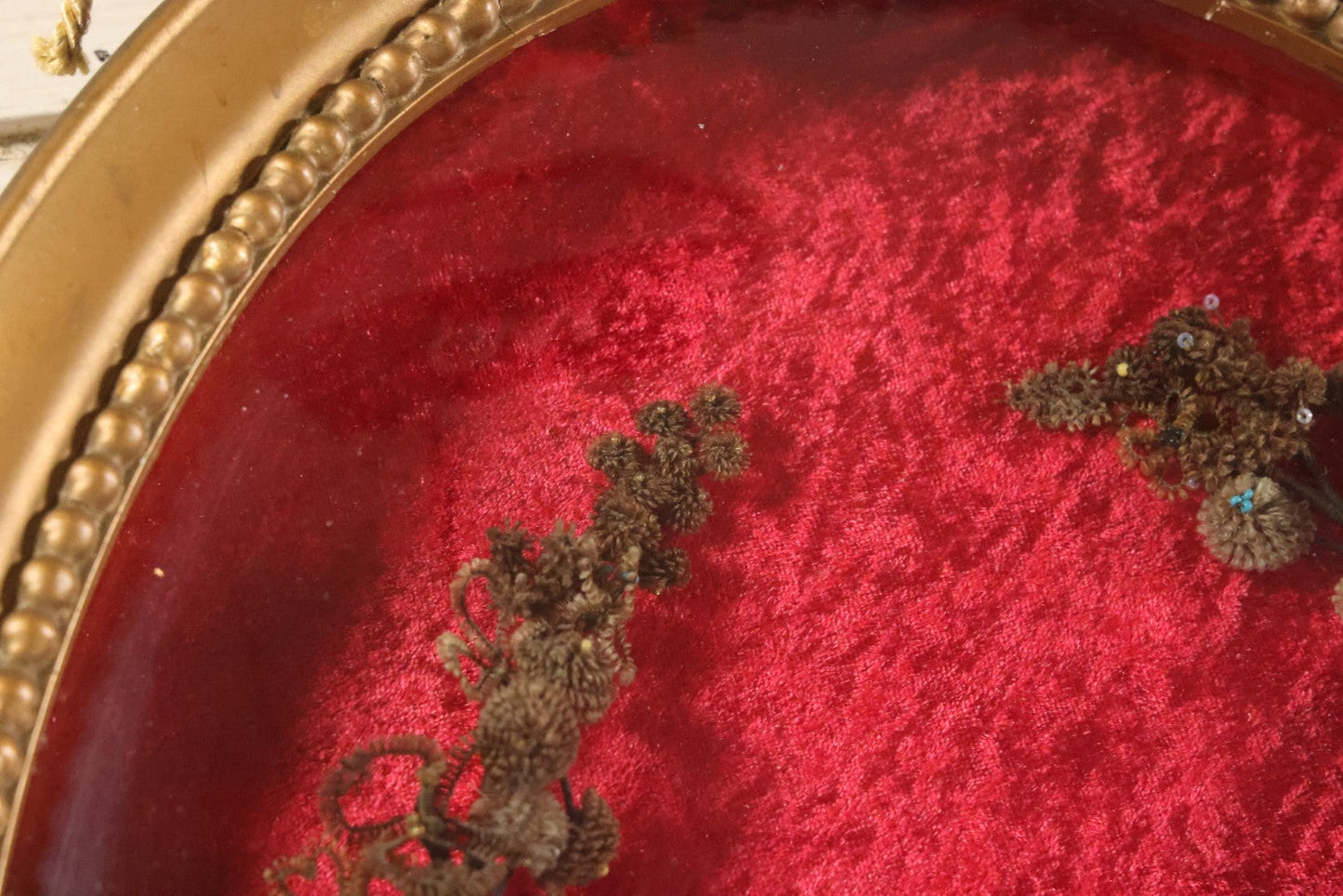 Lot 008 - Antique Victorian Human Hair Work Wreath In Oval Shadow Box With Bubble Glass, Refurbished Faux Red Velvet Back And Surround, 16" x 22"