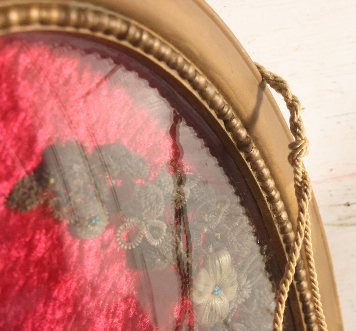 Lot 008 - Antique Victorian Human Hair Work Wreath In Oval Shadow Box With Bubble Glass, Refurbished Faux Red Velvet Back And Surround, 16" x 22"